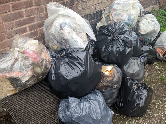 Helping Clear an Alleyway of Rubbish