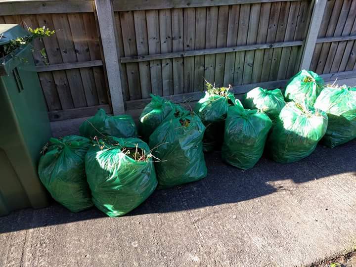 GoodGym York 10 green bin bags sitting by the wall...
